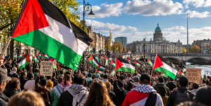 Thousands of people marching through Dublin in solidarity with Palestine, waving Palestinian flags near the River Liffey.